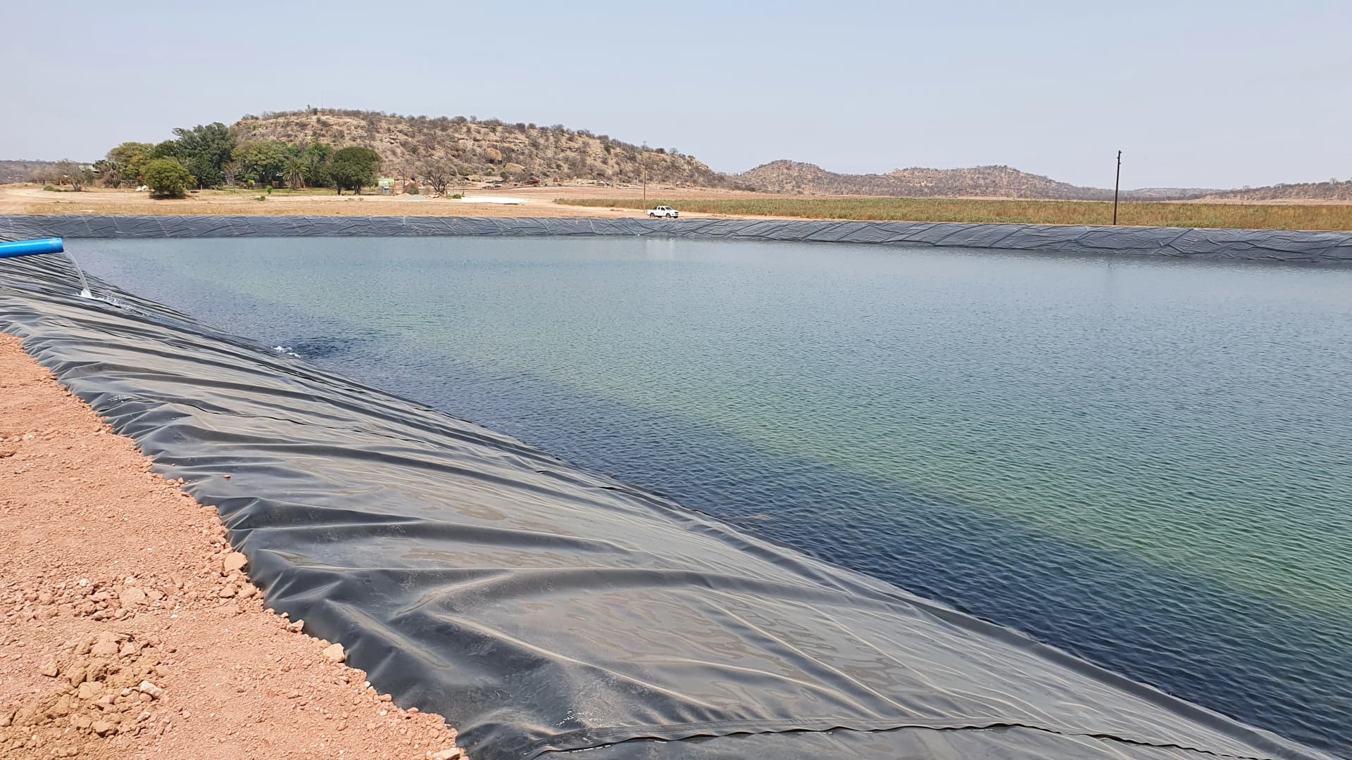 Damtech team installing HDPE dam lining for earth dam waterproofing in South Africa